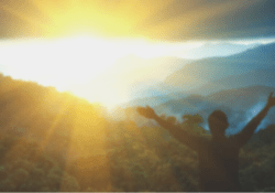 Man praying at sunrise blurred